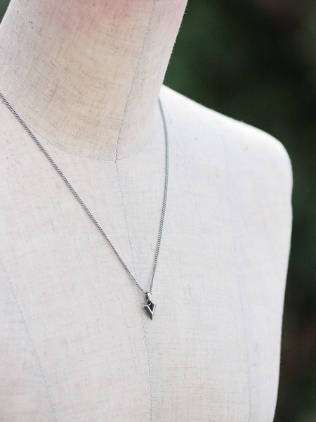 マネキンにStill Hard V SV Necklaceを着用させた写真、胸もとで控えめに輝くサイズ感が上品。